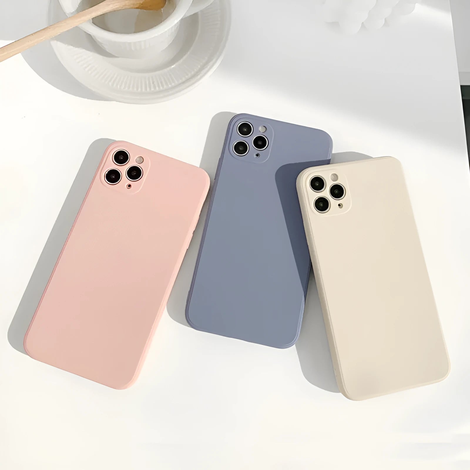Slim solid colour silicone TPU case for iPhone on a table.