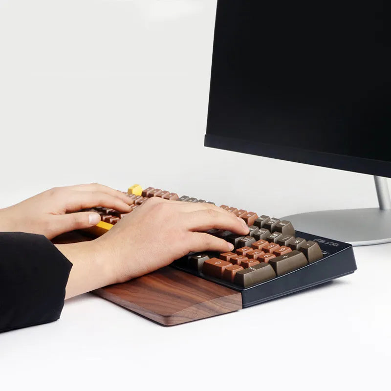 Solid walnut wood keyboard wrist rest for ergonomic forearm support.