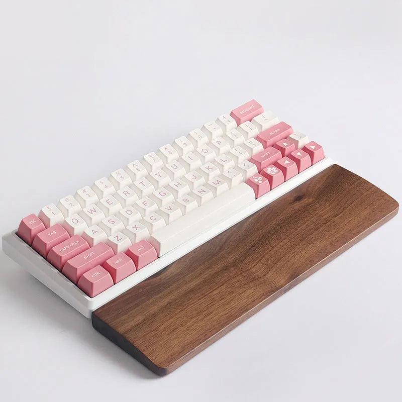 Solid walnut wood keyboard wrist rest for ergonomic forearm support.