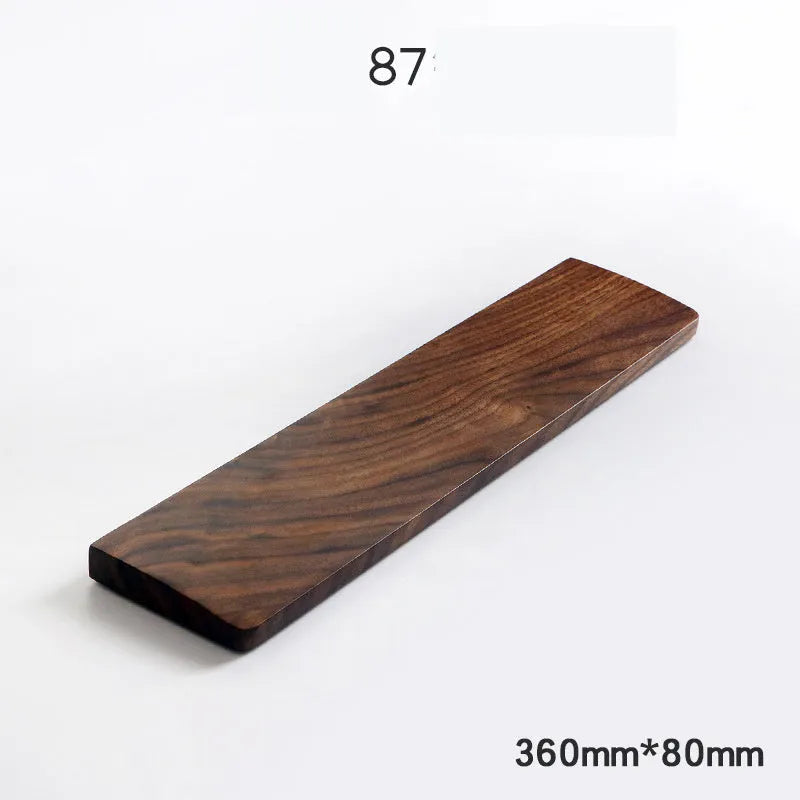 Solid walnut wood keyboard wrist rest for ergonomic forearm support.