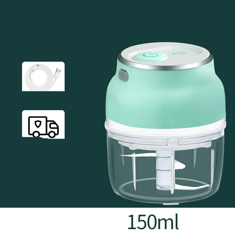 Mini electric food chopper with transparent cup and stainless steel blade on a kitchen counter.