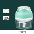 Mini electric food chopper with transparent cup and stainless steel blade on a kitchen counter.