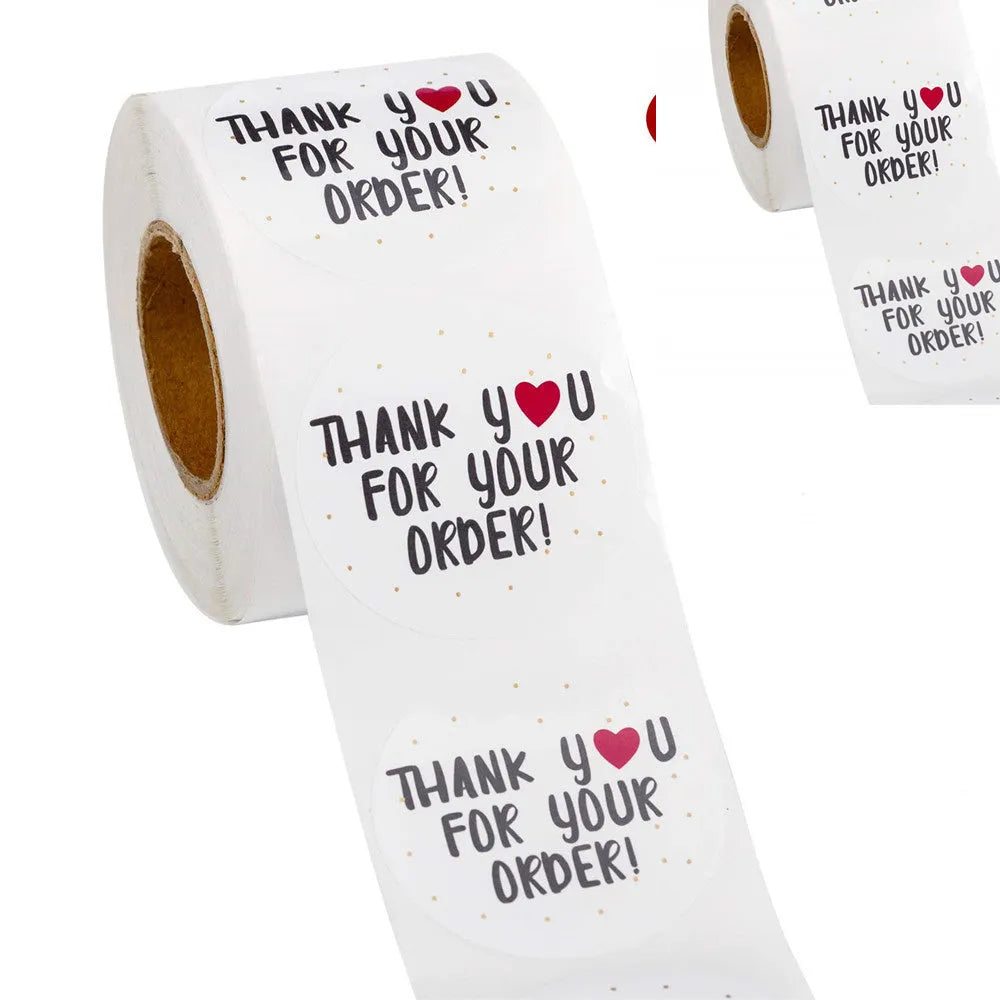 Round white thank you sticker with text on copper plate material, 2.5cm diameter, roll packaging shown