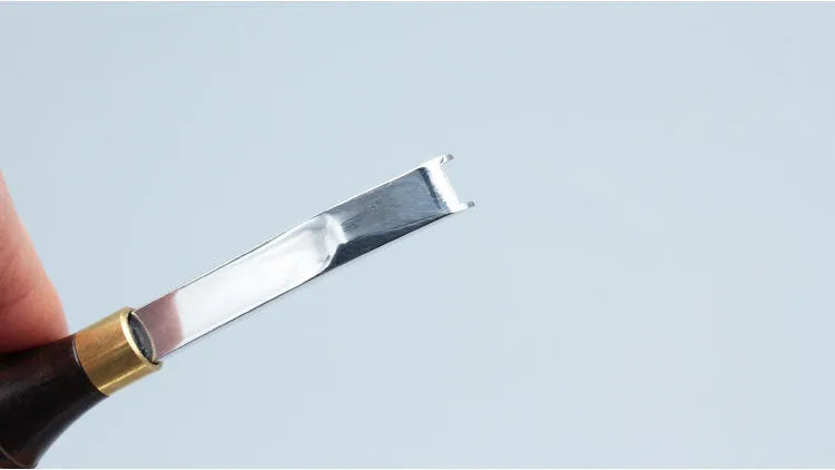 Model 02 leatherworking hand tool with wooden handle and wide metal shovel edge for thinning.