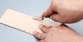 Model 02 leatherworking hand tool with wooden handle and wide metal shovel edge for thinning.