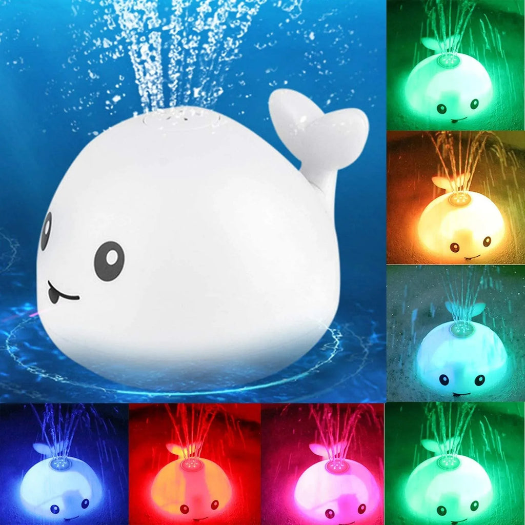 White and blue electric whale bath toy spraying water with flashing lights on a bathroom surface.
