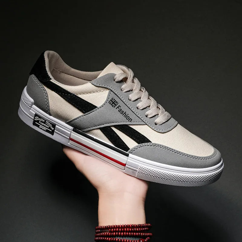 Men's canvas sneakers in black with rubber sole, round toe, and front tie lace closure.