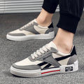 Men's canvas sneakers in black with rubber sole, round toe, and front tie lace closure.
