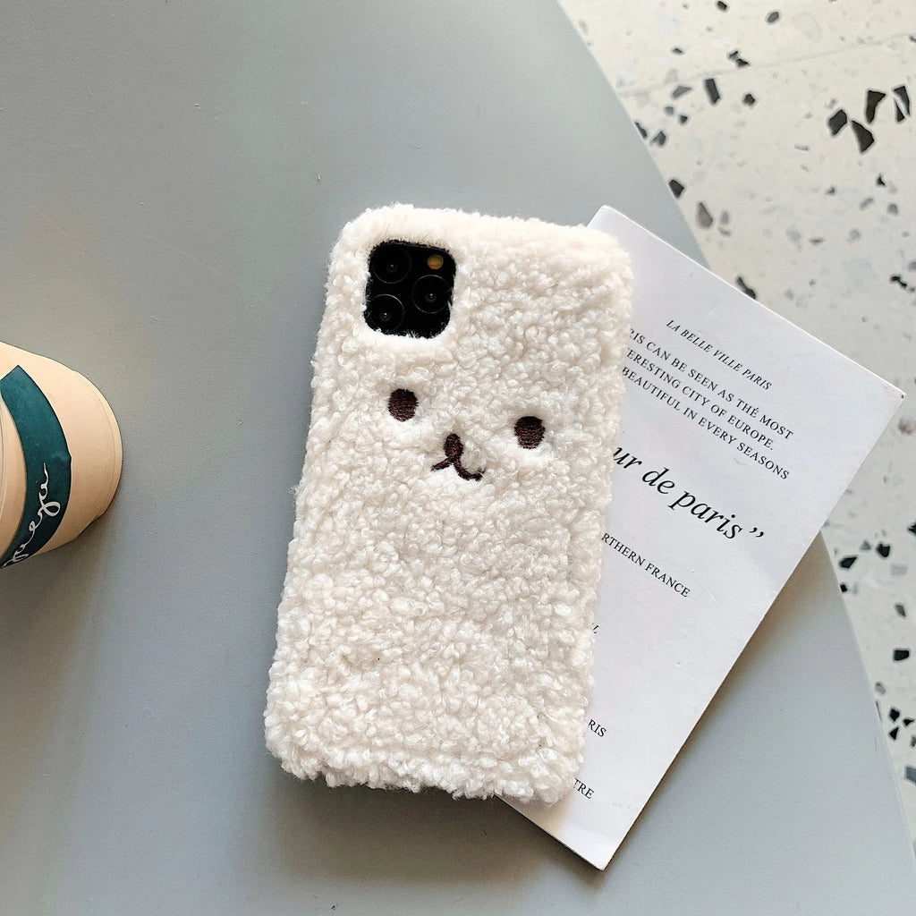 Brown embroidered plush bear face on a soft TPU iPhone phone case.