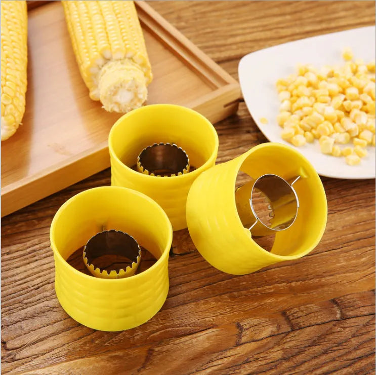 Yellow manual corn thresher with corn-cob shape and textured PP grip.