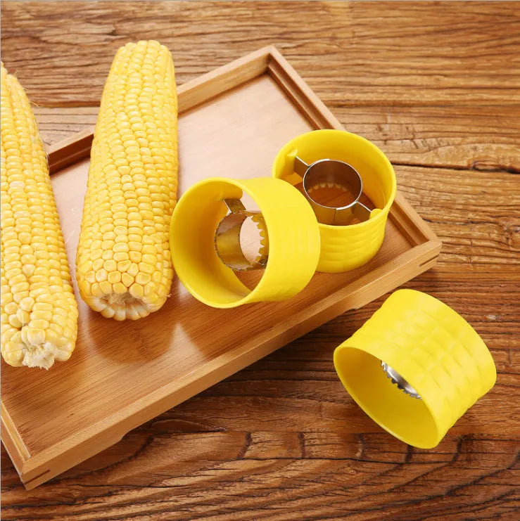 Yellow manual corn thresher with corn-cob shape and textured PP grip.