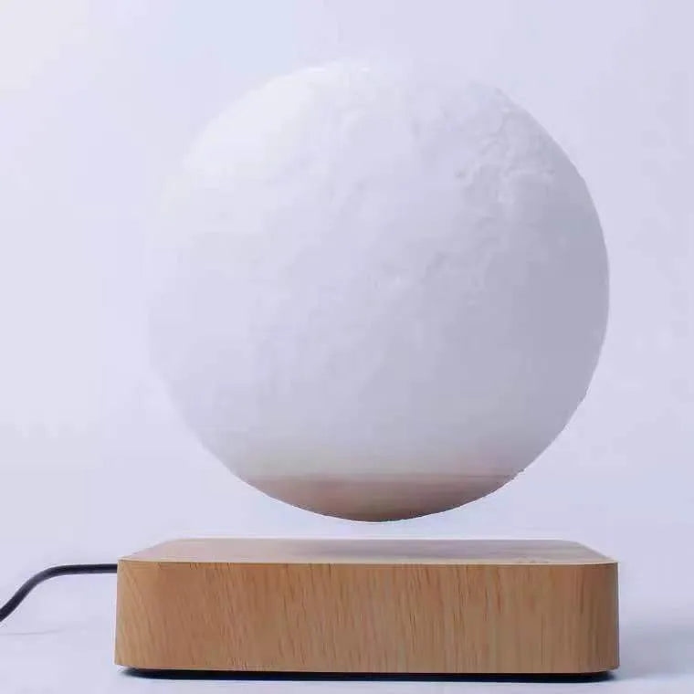 Magnetic levitation moon night light with 14cm 3D-printed planet suspended above a dark peach wood base