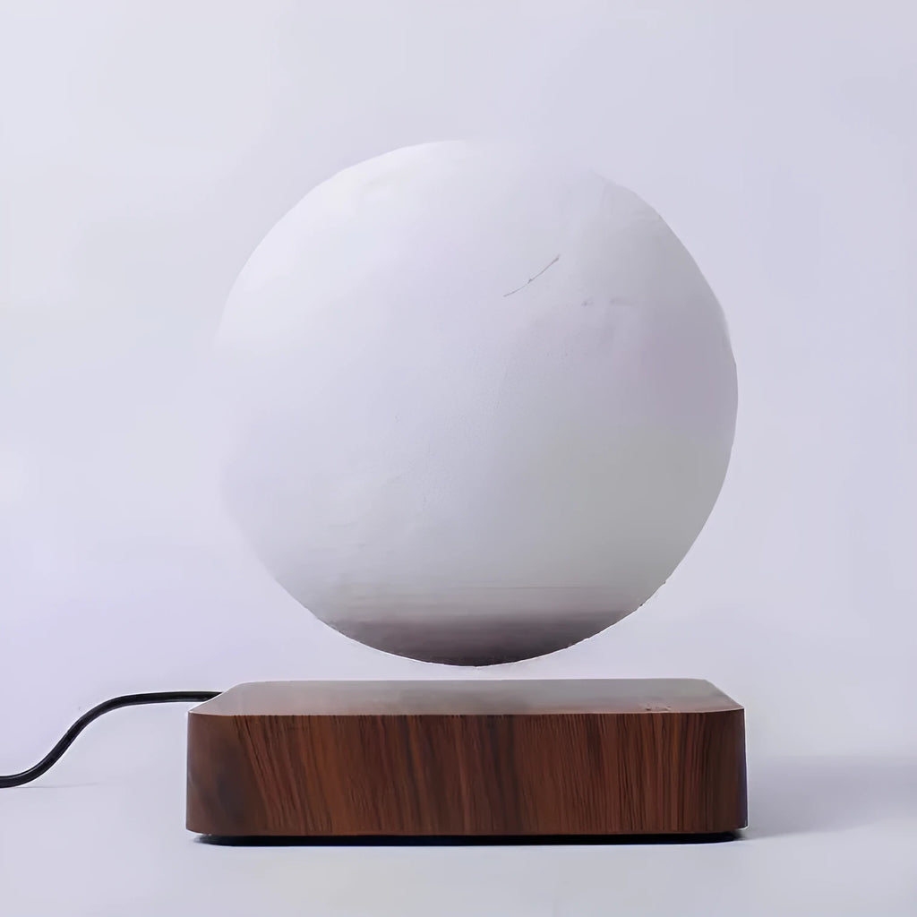 Magnetic levitation moon night light with 14cm 3D-printed planet suspended above a dark peach wood base