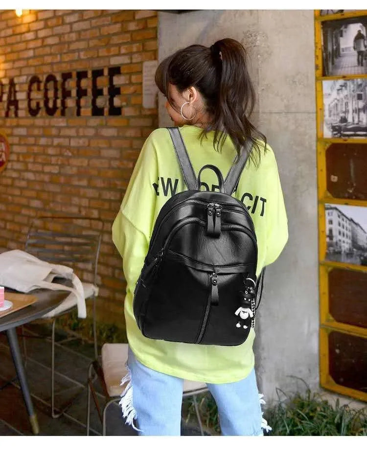 Black soft-surface PU leather backpack with double straps, shown with a capacity of 20-35 litres.