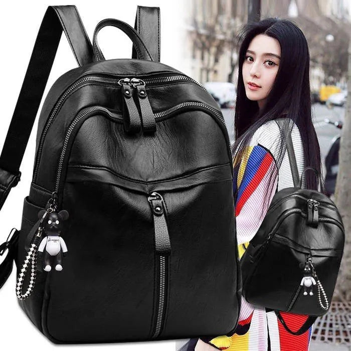 Black soft-surface PU leather backpack with double straps, shown with a capacity of 20-35 litres.