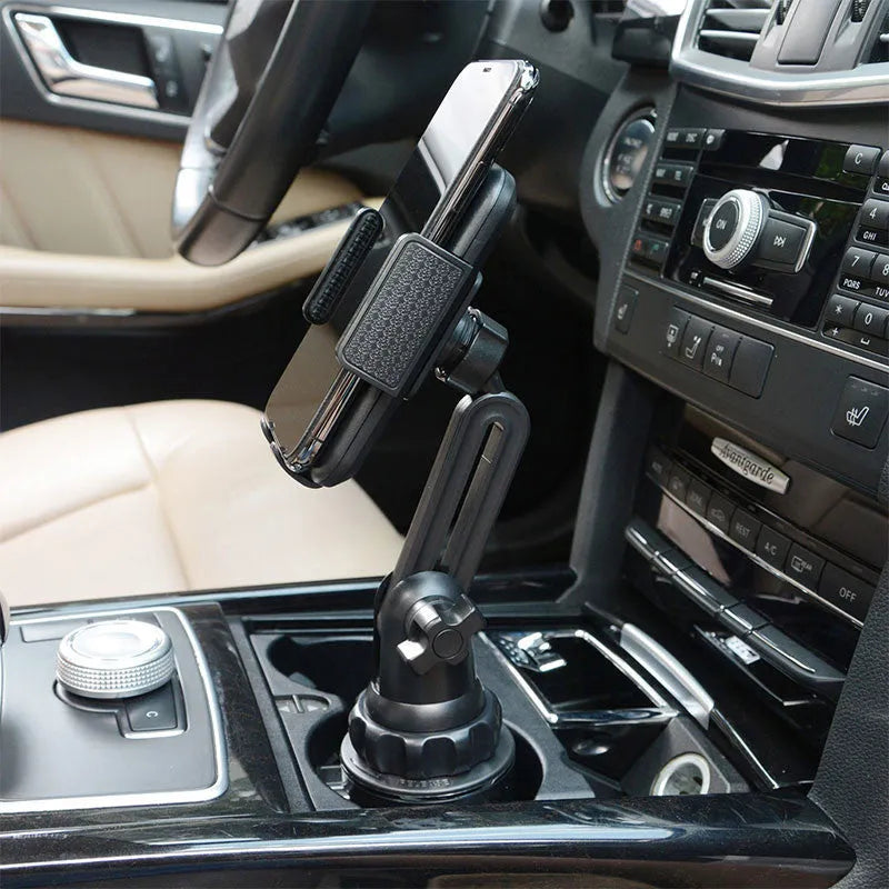 Black ABS car phone holder with 360-degree rotating head and adjustable height on a car dashboard.