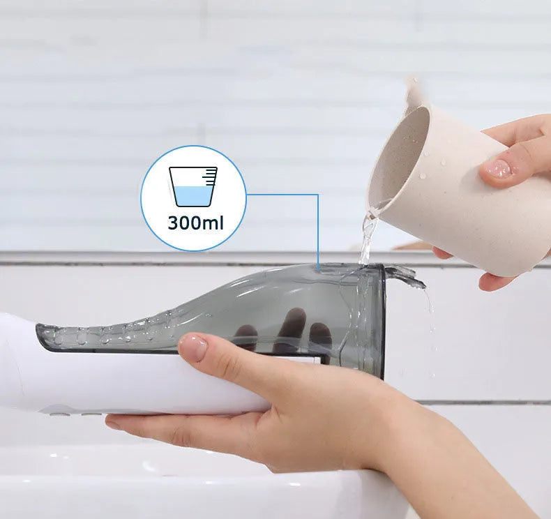 White portable oral irrigator water flosser with a large water tank and multiple nozzles on a bathroom counter.