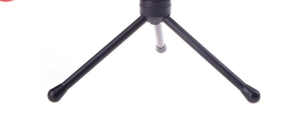 Black wired PC microphone with a detached holder clip and a separate desk bracket on a white background.