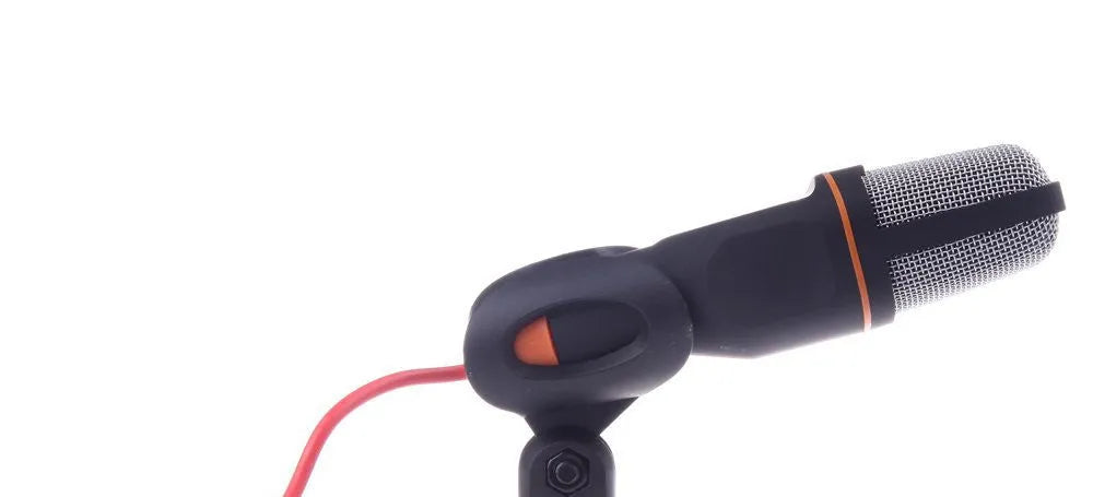 Black wired PC microphone with a detached holder clip and a separate desk bracket on a white background.