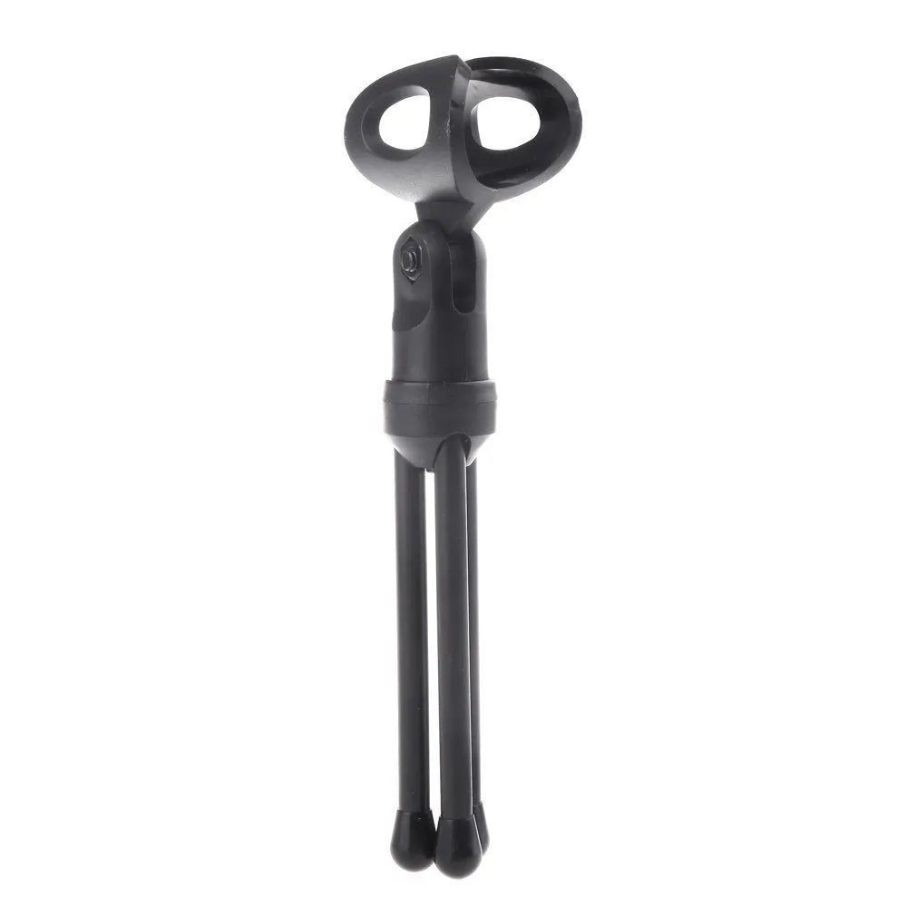Black wired PC microphone with a detached holder clip and a separate desk bracket on a white background.
