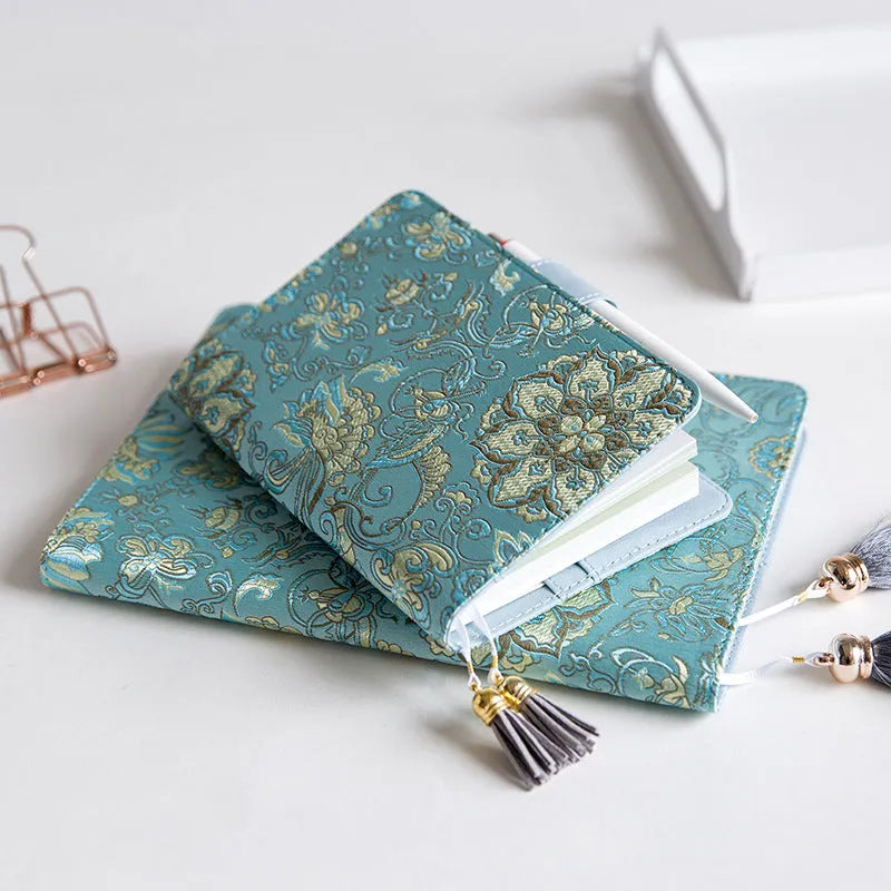 Blue floral fabric notebook open showing pages, available in A5 and A6 sizes.
