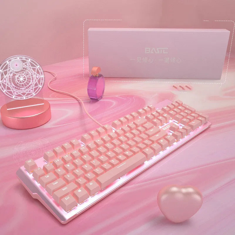 Pink wired mechanical keyboard and matching mouse set on a desk.