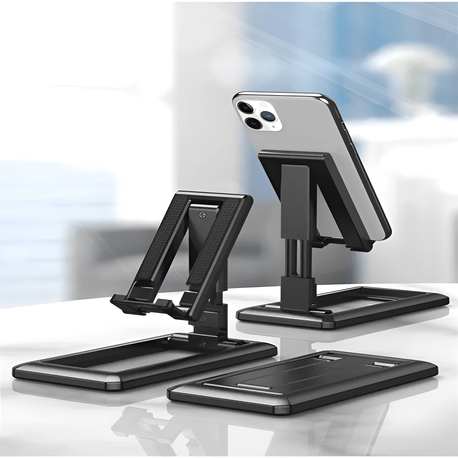 Retractable mobile phone stand shown extended for use and folded flat for pocket storage