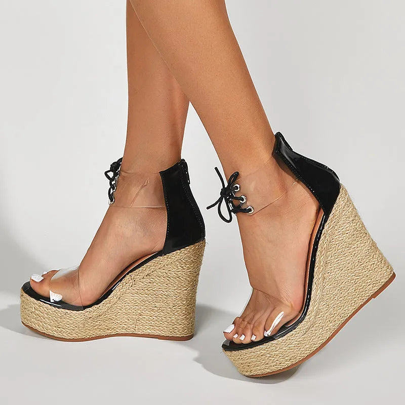 Black women's wedge sandals with hemp rope detail, front tie closure, and a high platform sole.