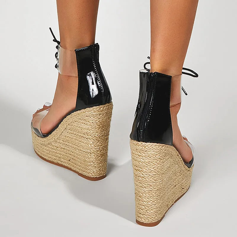 Black women's wedge sandals with hemp rope detail, front tie closure, and a high platform sole.