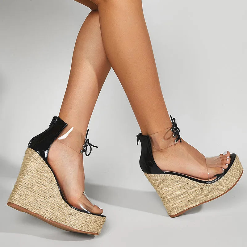 Black women's wedge sandals with hemp rope detail, front tie closure, and a high platform sole.