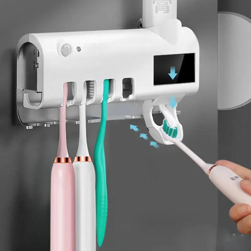 Intelligent UV toothbrush steriliser unit with automatic toothpaste squeezer mounted on wall