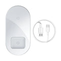 Baseus Minimalist 2-in-1 Wireless Charger Pro in black on a desk, charging a phone and AirPods case.