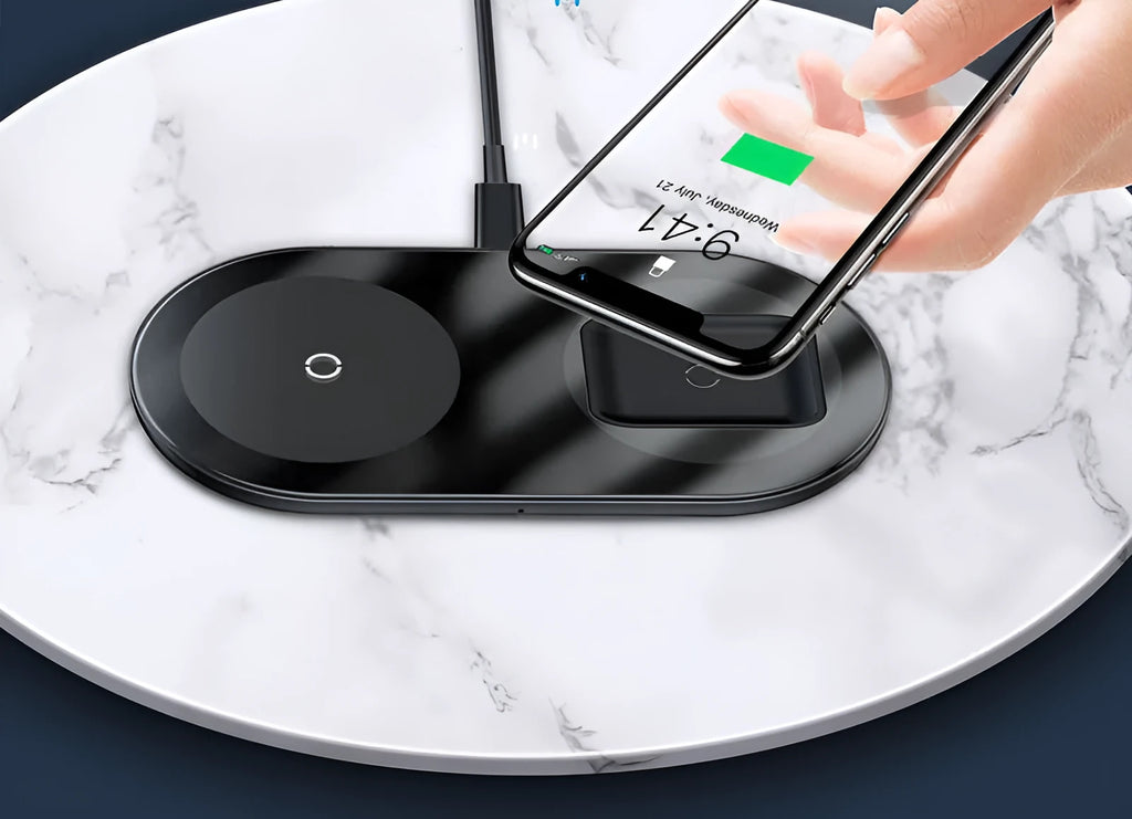 Baseus Minimalist 2-in-1 Wireless Charger Pro in black on a desk, charging a phone and AirPods case.