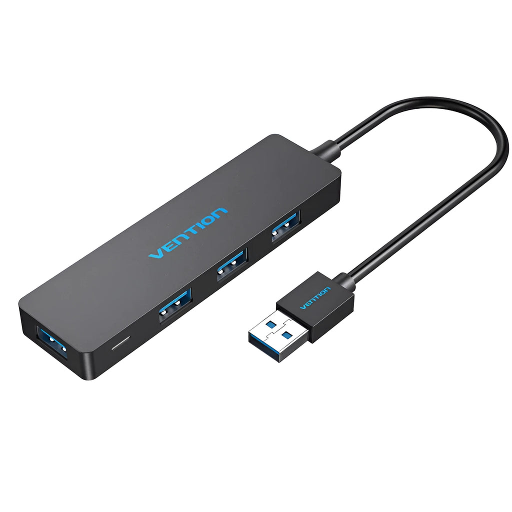 Black four-port USB 3.0 hub splitter with a short connected cable on a desktop.