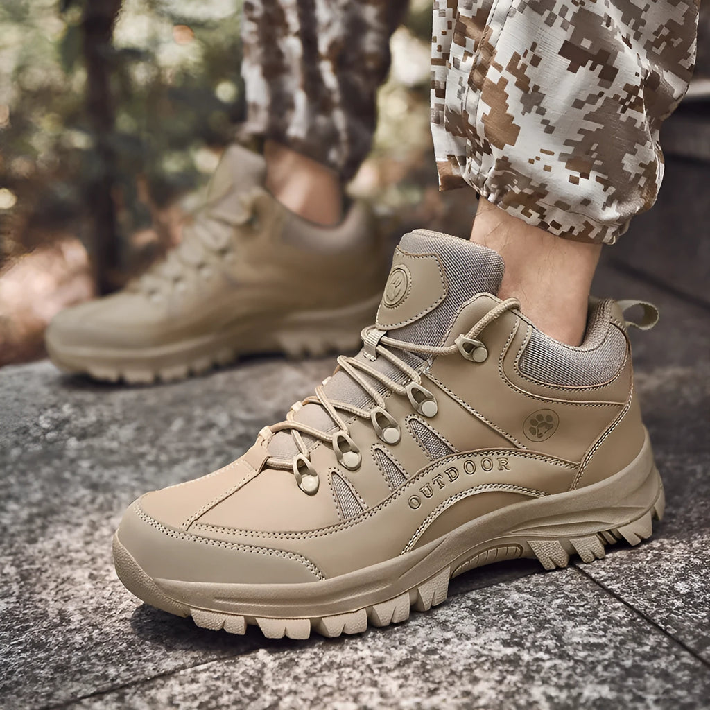Men's military-style hiking boots in black with PU upper and rubber sole, shown on outdoor ground.