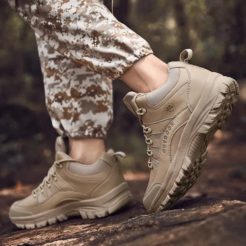 Men's military-style hiking boots in black with PU upper and rubber sole, shown on outdoor ground.