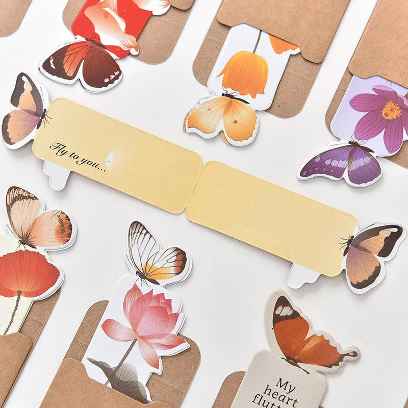 A single butterfly-shaped paper bookmark on a white background, showing its flat design and approximate 13.5cm by 5.5cm size.