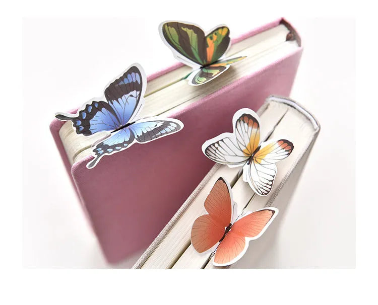 A single butterfly-shaped paper bookmark on a white background, showing its flat design and approximate 13.5cm by 5.5cm size.