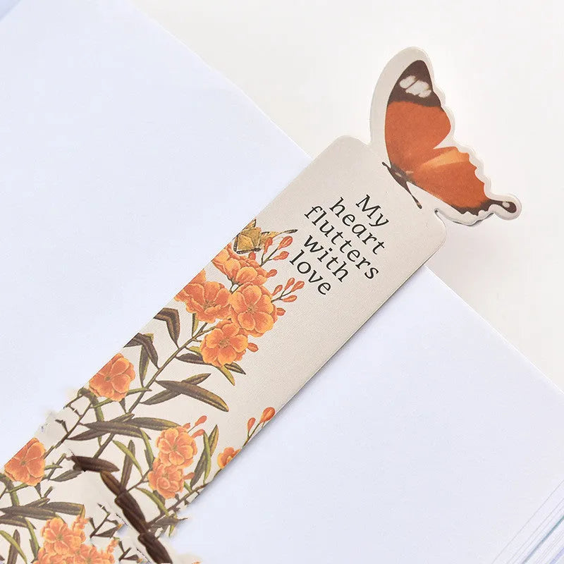 A single butterfly-shaped paper bookmark on a white background, showing its flat design and approximate 13.5cm by 5.5cm size.