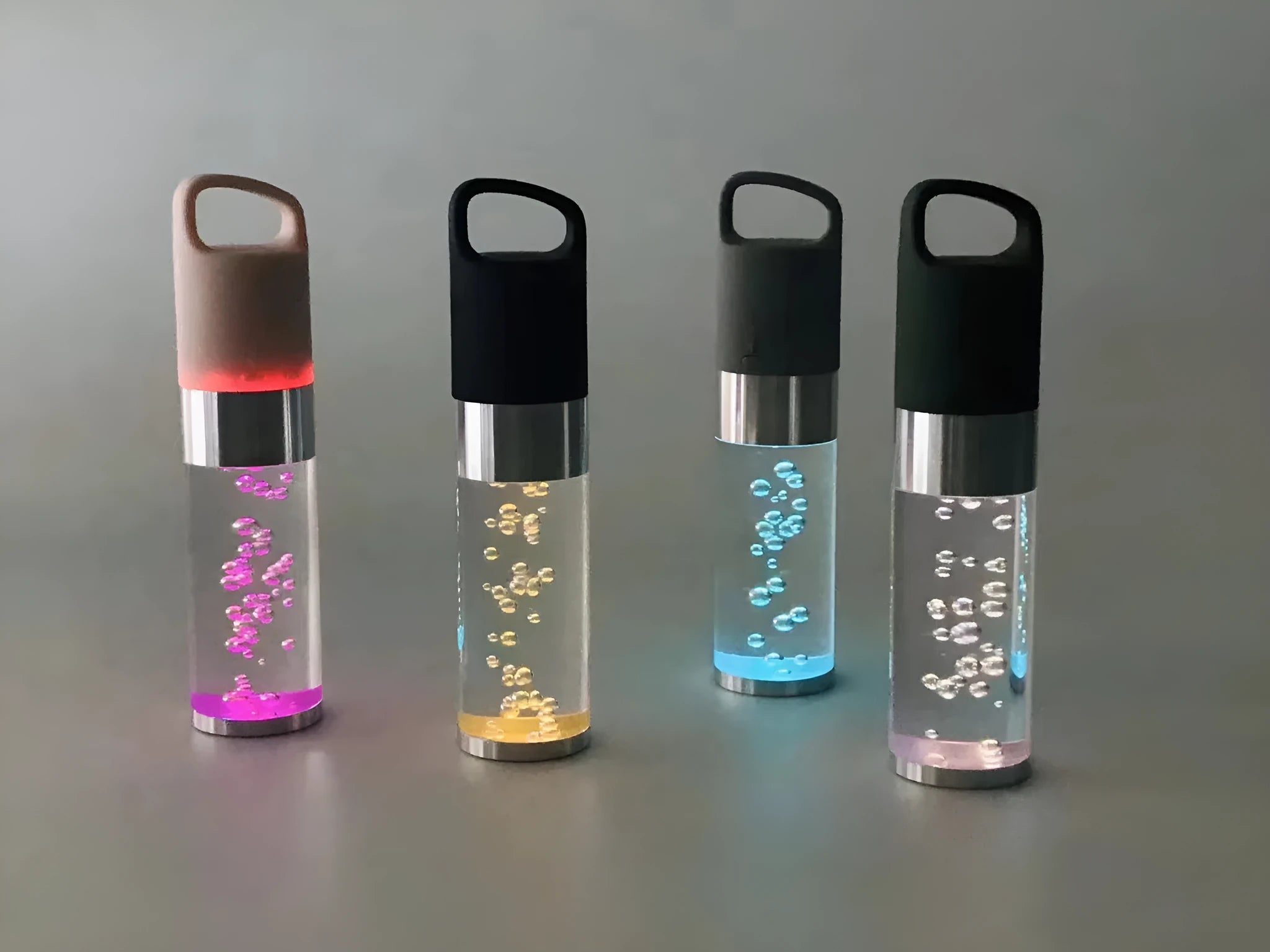 Colourful crystal light Bluetooth portable speaker in pink, black, silver grey, or green.
