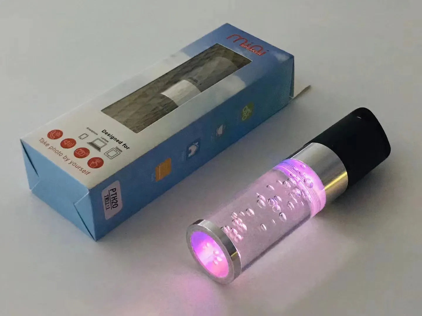 Colourful crystal light Bluetooth portable speaker in pink, black, silver grey, or green.