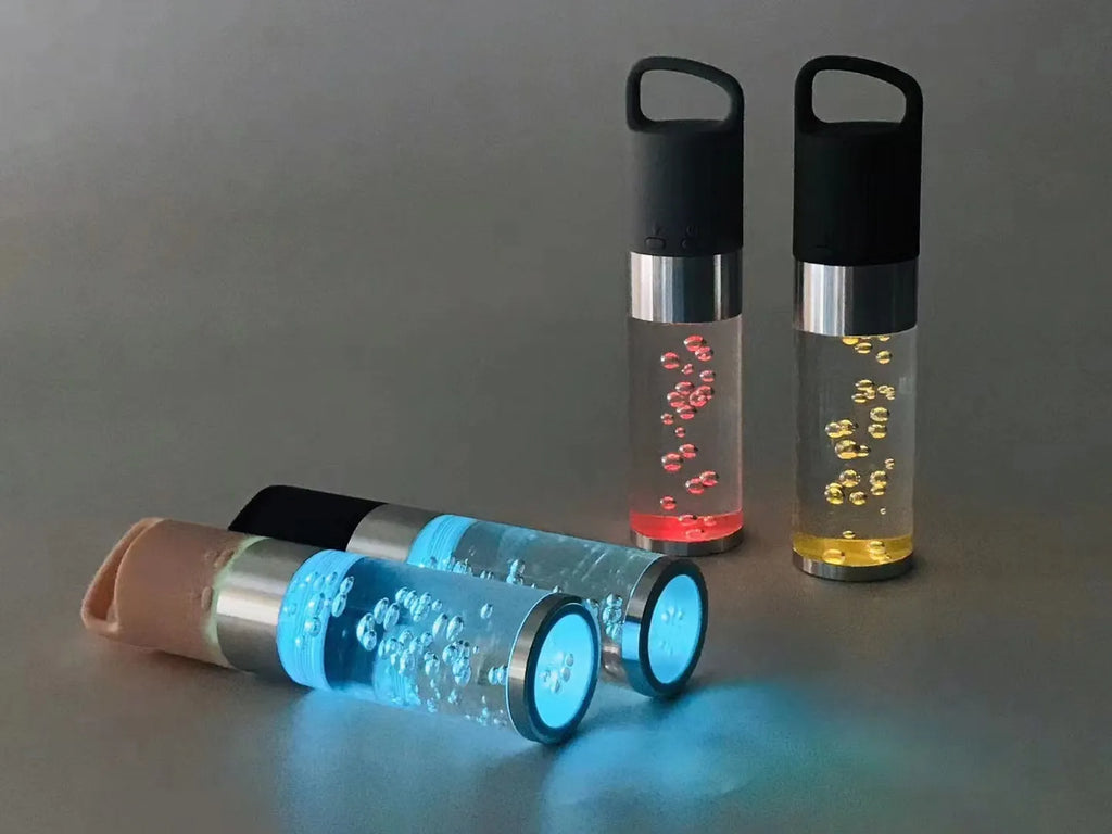 Colourful crystal light Bluetooth portable speaker in pink, black, silver grey, or green.