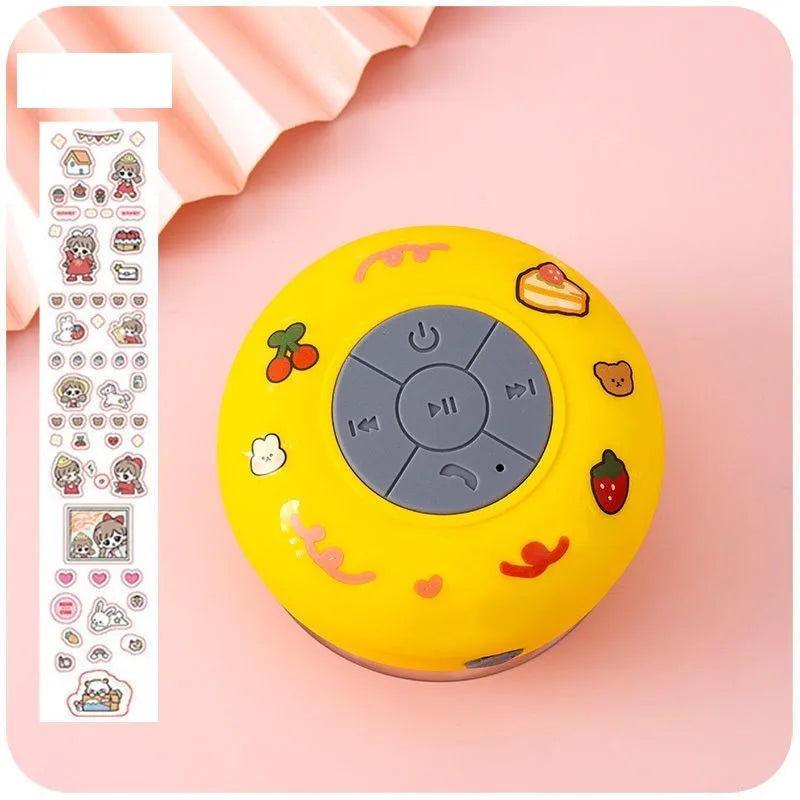 Small waterproof silicone Bluetooth speaker with a suction cup base in blue colour.