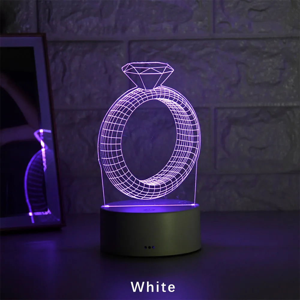3D diamond ring design LED night light with colour changing modes on a black background.