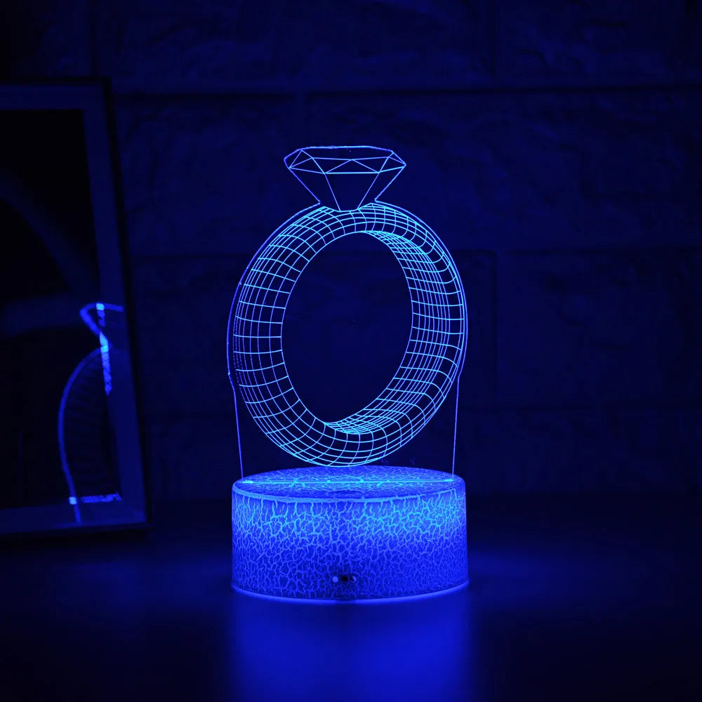 3D diamond ring design LED night light with colour changing modes on a black background.