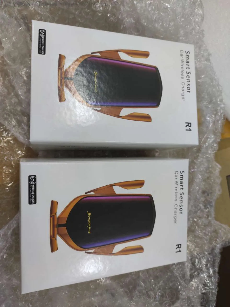 Magic Clip R1 automatic wireless charging car phone holder in gold on a dashboard.