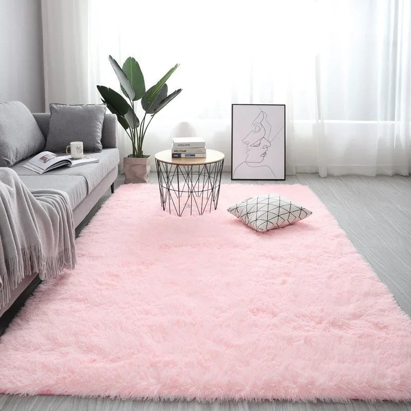 Rectangle fluffy plush carpet rug with anti-slip backing in a light colour on a wooden floor