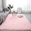 Rectangle fluffy plush carpet rug with anti-slip backing in a light colour on a wooden floor