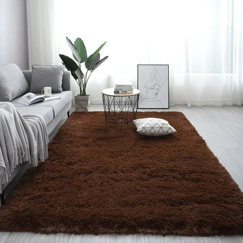 Rectangle fluffy plush carpet rug with anti-slip backing in a light colour on a wooden floor