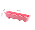 Flexible silicone ice tray producing large ice spheres, hockey puck shapes, and pentagon ice on a kitchen counter.